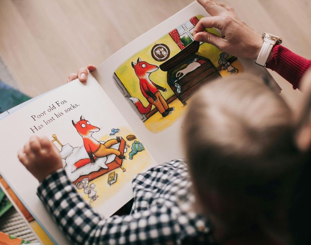 Child reading with storybook in lap
